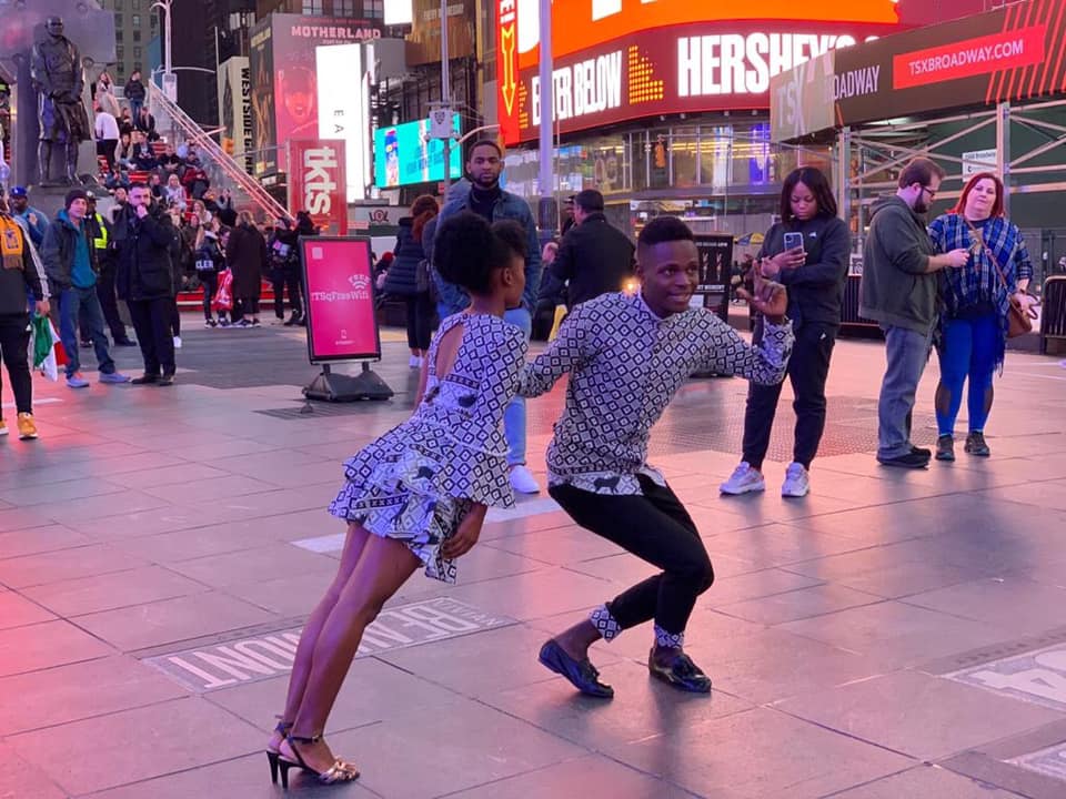 Ana and Toy in an acrobatic move in the middle of a crowded street in New York