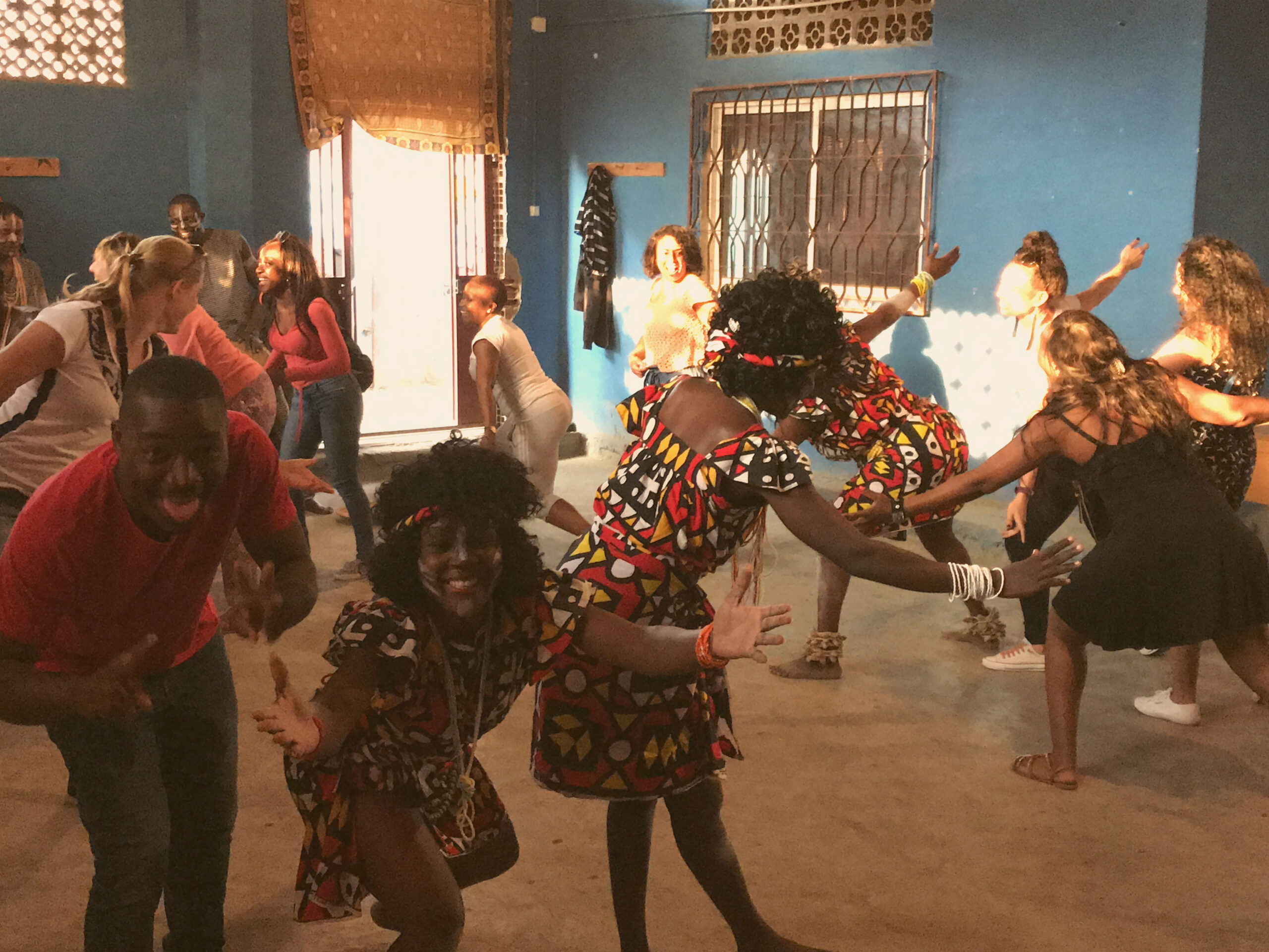 A group of people dancing in a circle.